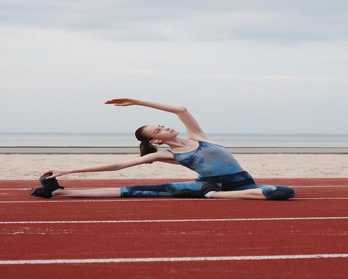Woman doing yoga fitness outdoors in morning